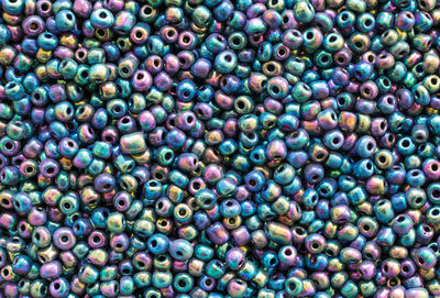 Background texture of multicolored iridescent beads closeup. seamless beads texture. 