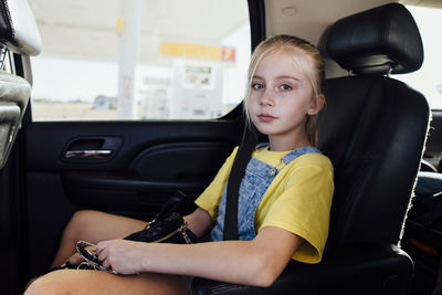 Portrait of girl sitting in car