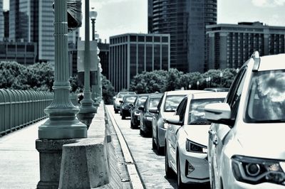 Vehicles on road amidst buildings in city