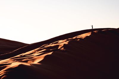 Low angle view of desert against clear sky