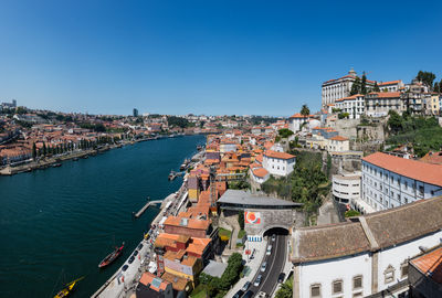 High angle view of buildings in city against clear blue sky