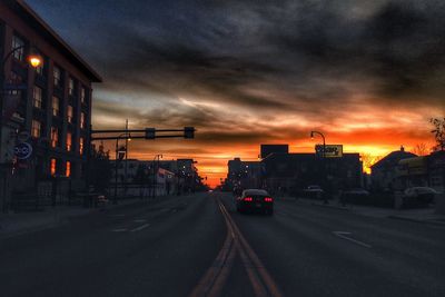 Road in city against cloudy sky