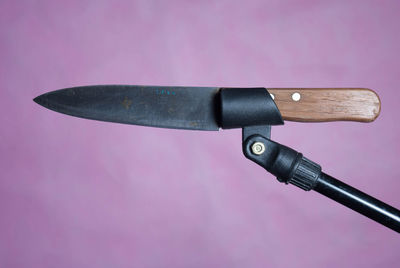 Close-up of knife against purple background