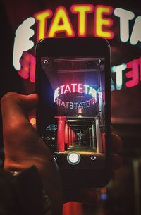 Illuminated telephone booth in city