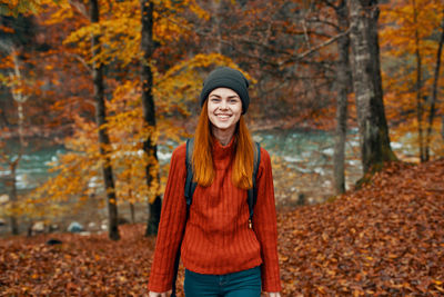 Portrait of smiling young man standing during autumn