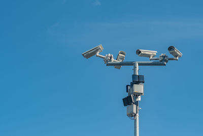 Low angle view of floodlight against clear blue sky