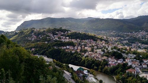 High angle view of townscape and mountains against sky