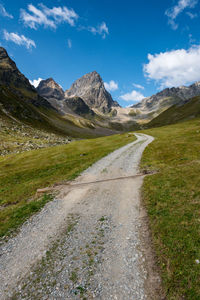 Road by landscape against sky