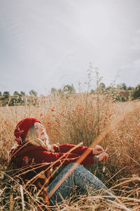 Woman on field against sky