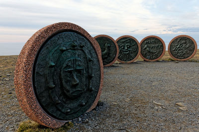 Close-up of old rusty wheel against sky