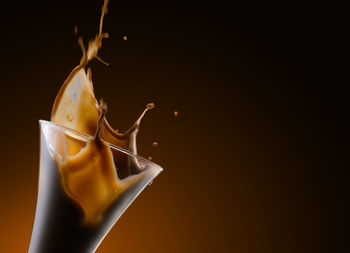 Close-up of coffee cup against black background