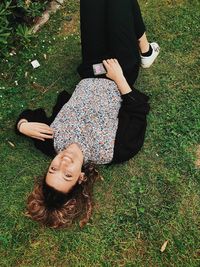 High angle view of woman lying on field