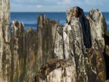 Close-up of rock formation in sea against sky