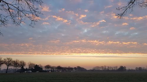 Scenic view of landscape against sky at sunset