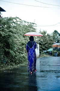 Rear view of woman standing in water