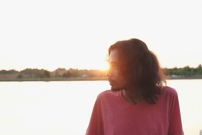 Woman looking at view of sunset