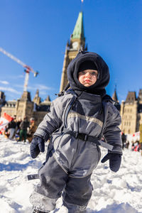 Rear view of man standing on snow