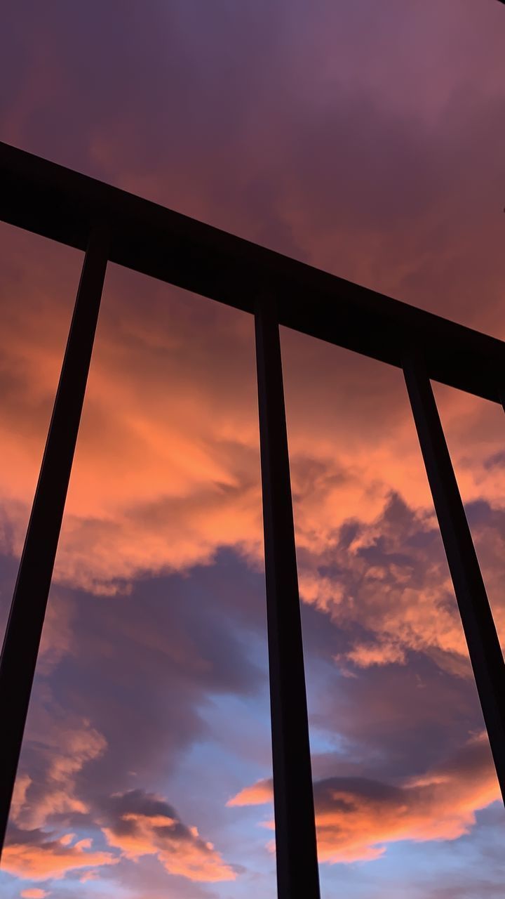 LOW ANGLE VIEW OF SILHOUETTE METAL AGAINST ORANGE SKY