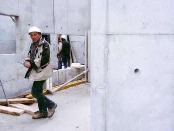 Portrait of worker walking at construction site