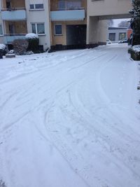 Snow covered road in city