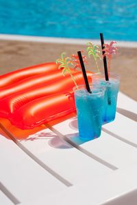 High angle view of drink on table at swimming pool