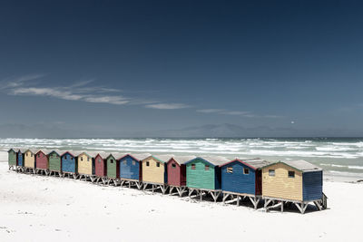 Famous colorful beach houses in muizenberg near cape town, south africa  against blue sky