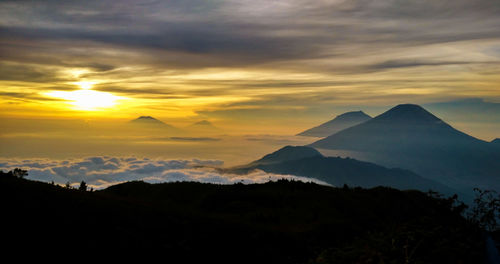 Scenic view of silhouette mountains against sky during sunset