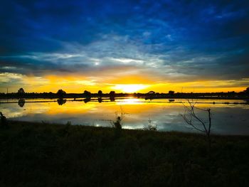 Scenic view of lake against sky during sunset