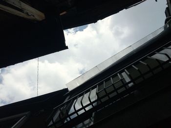 Low angle view of building against cloudy sky