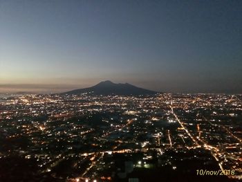 High angle view of city lit up at night