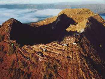 Scenic view of mountain range against cloudy sky