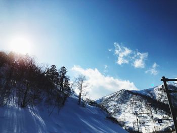 Low angle view of snowcapped mountain against sky