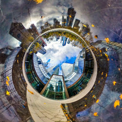 Digital composite image of ferris wheel and buildings in city