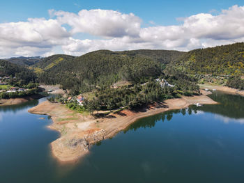 Scenic view of lake and mountains against sky