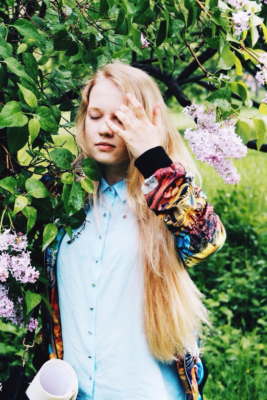 person, lifestyles, leisure activity, flower, casual clothing, young adult, young women, long hair, smiling, girls, front view, looking at camera, childhood, portrait, plant, elementary age, waist up, happiness