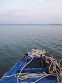 Boat moored in sea against sky