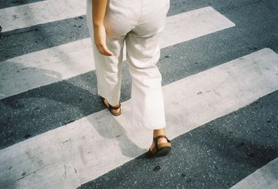 Low section of man standing on street