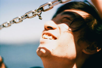 Close-up of young woman against sea