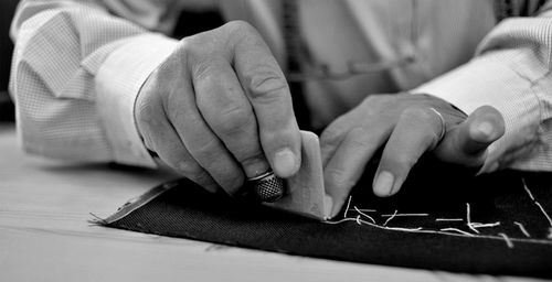 Close-up of man holding hands on table