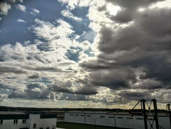 Pier on sea against cloudy sky