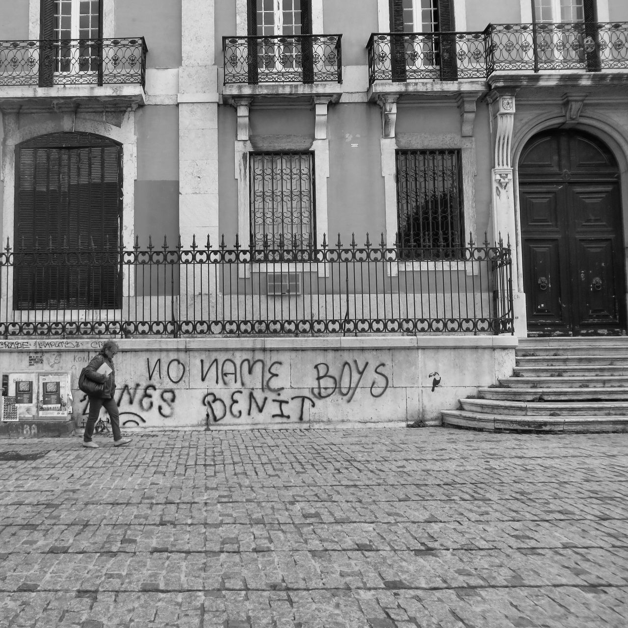 architecture, building exterior, built structure, city, lifestyles, men, street, building, full length, walking, sidewalk, leisure activity, day, outdoors, cobblestone, person, footpath, city life