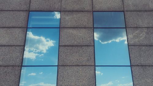 Low angle view of reflection of clouds in sky