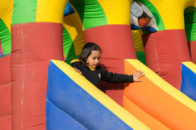 Cute little girl having fun on an inflatable slide