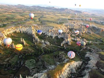 High angle view of hot air balloons on landscape at cappadocia