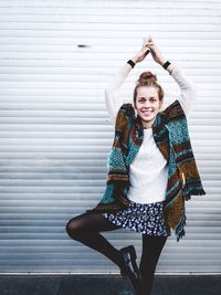 Woman standing against shutter