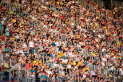 Defocused image of people sitting in stadium