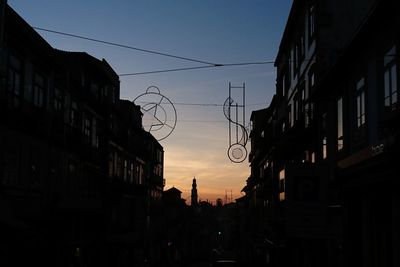 Low angle view of silhouette buildings against sky at sunset