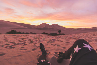 Low section of man relaxing on shore