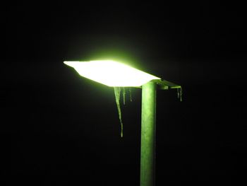 Close-up of illuminated lamp against black background