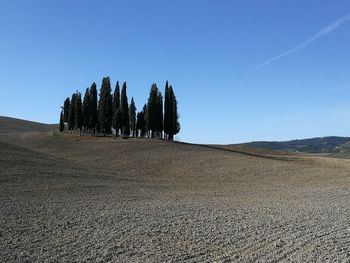 Panoramic view of land against clear blue sky in tuscany
